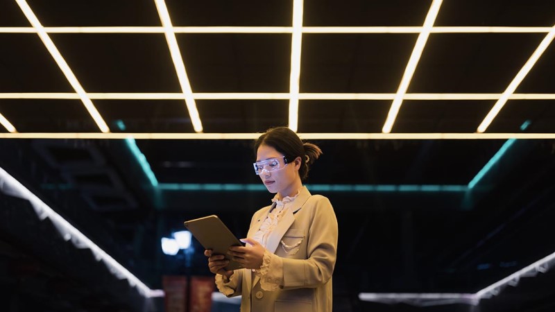 A woman is looking into tablet