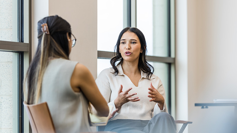 Two women are talking to each other