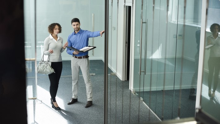 A person is showing the office to client