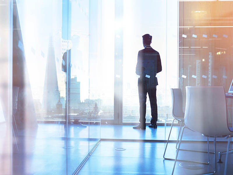 Man looking through a glass window