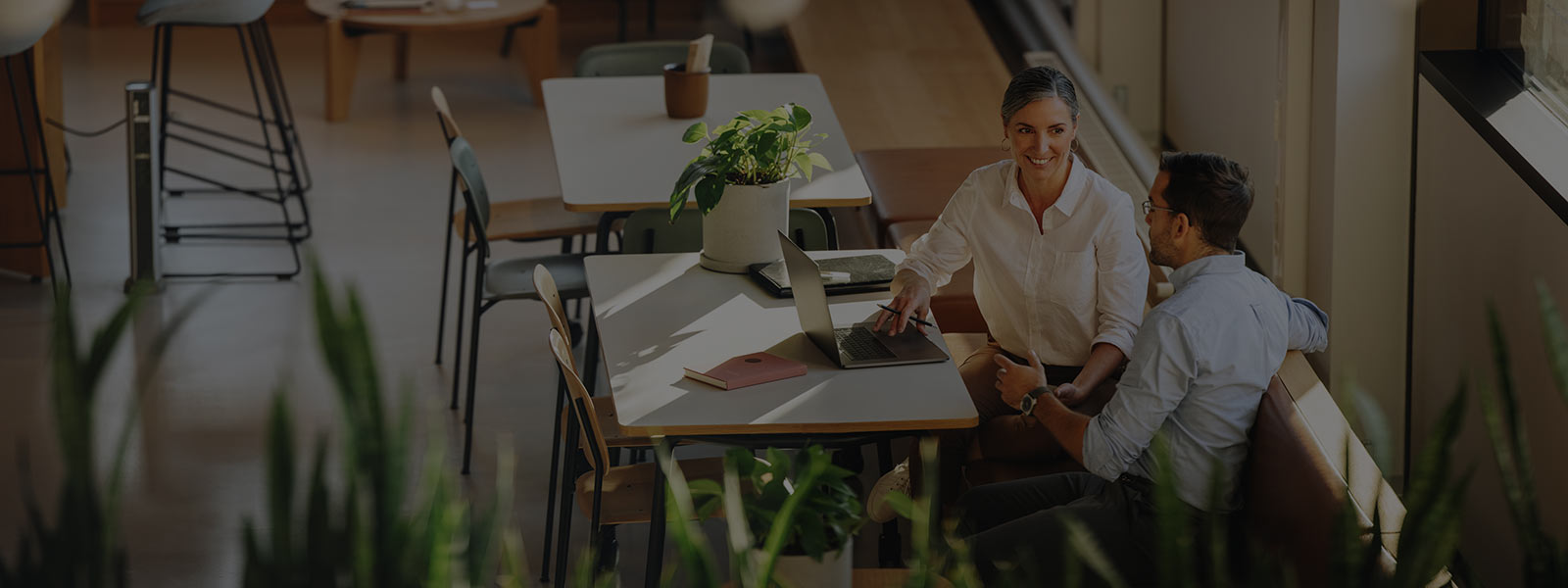 A woman and a boy working in office