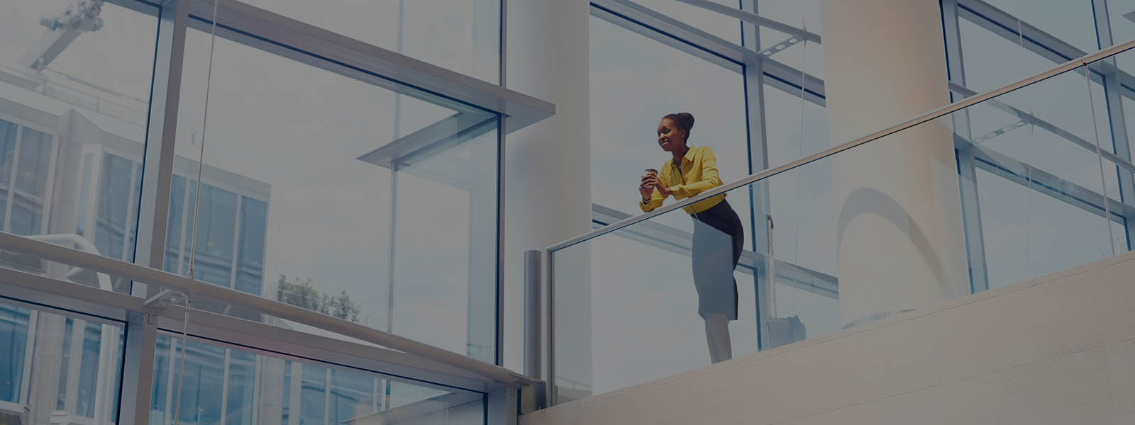 A female employee enjoying her coffee inside the real estate office