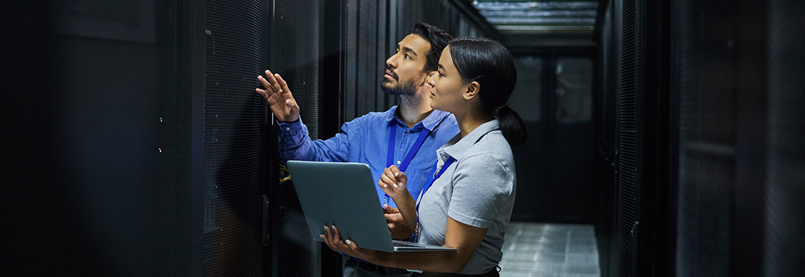 Two people discussing with laptop at cyber security room