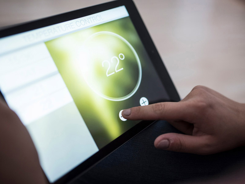 Persons adjusting the temperature through ipad