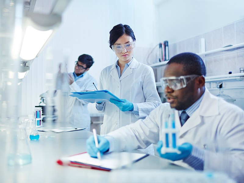 Life sciences researcher working in laboratory and making notes for the new research