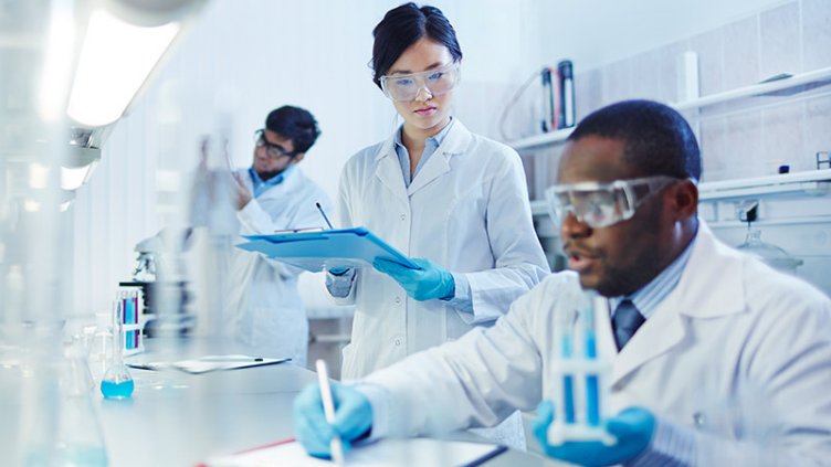 Life sciences researcher working in laboratory and making notes for the new research