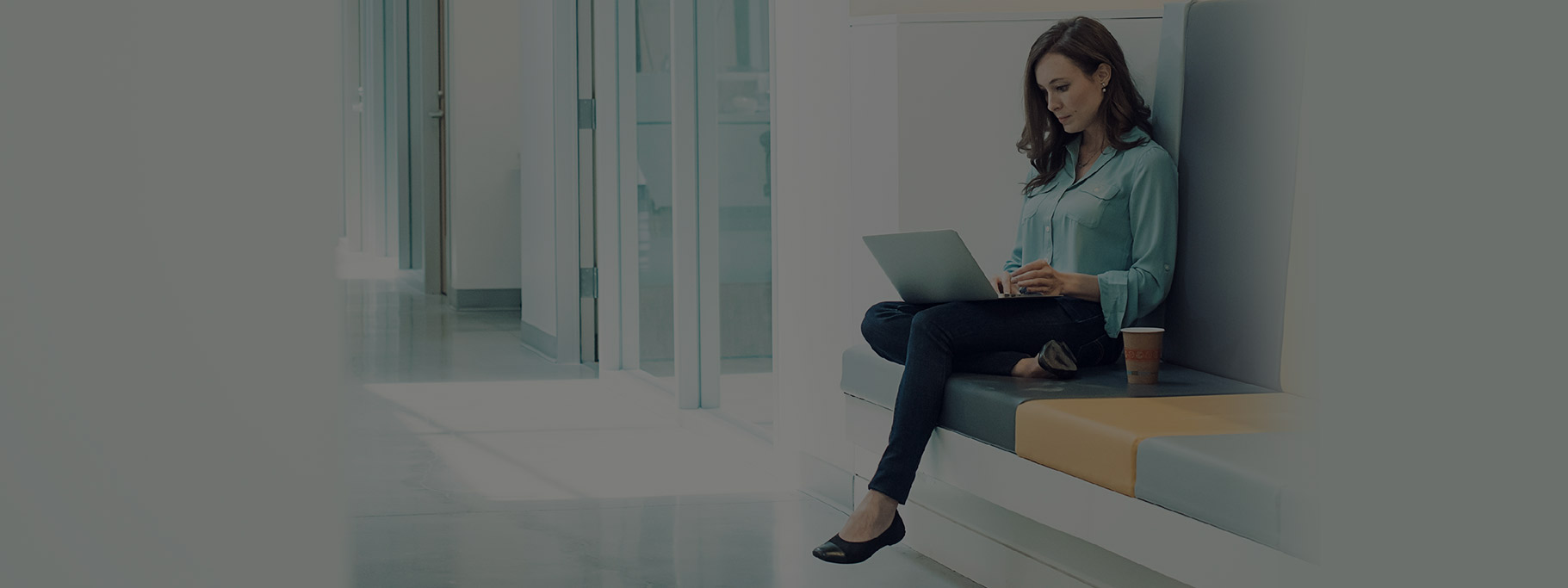 Woman sitting and working on laptop