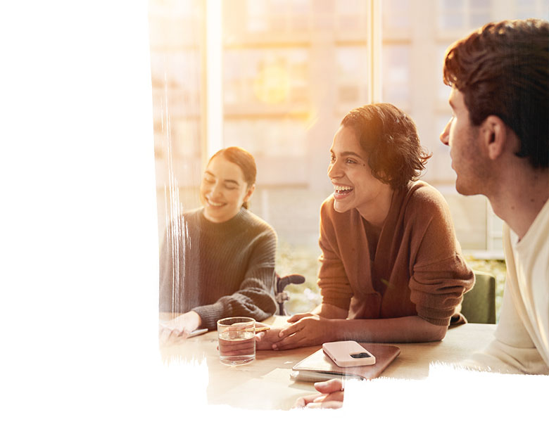 people sitting across a table smiling