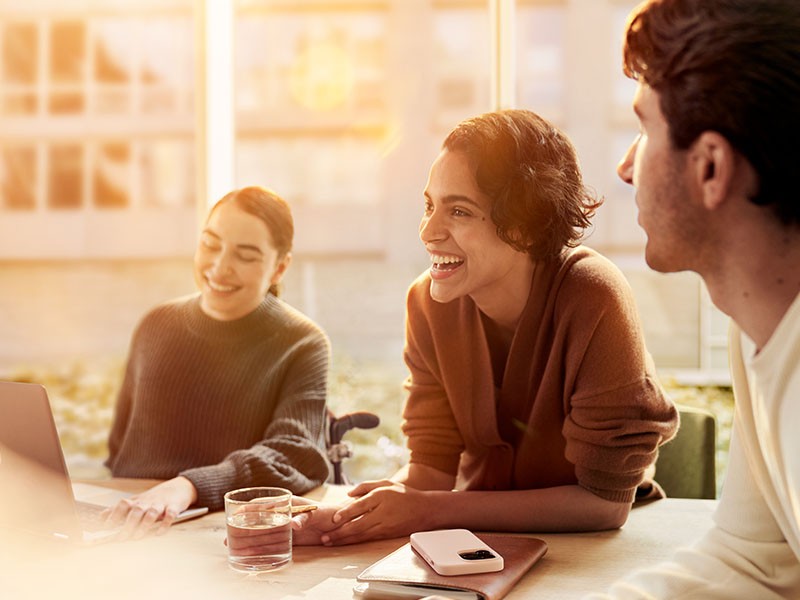 people sitting across a table smiling