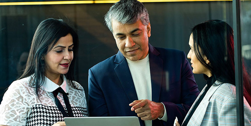 three colleagues discussing strategies