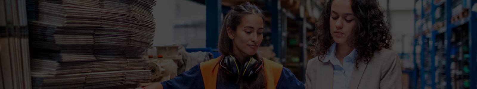 Two women discussing in a warehouse