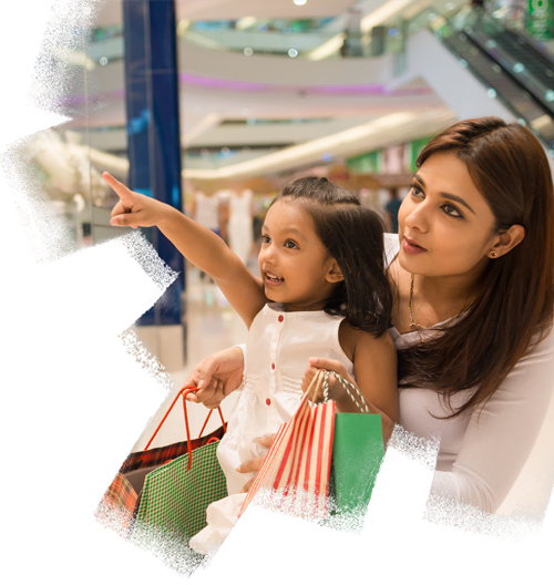 Little girl showing something in the showcase to her mother