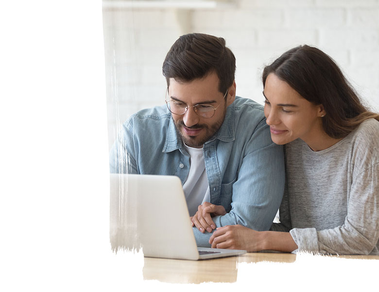 a man and a woman looking at a laptop screen