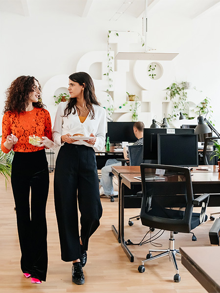 Colleagues walk through a modern office set up