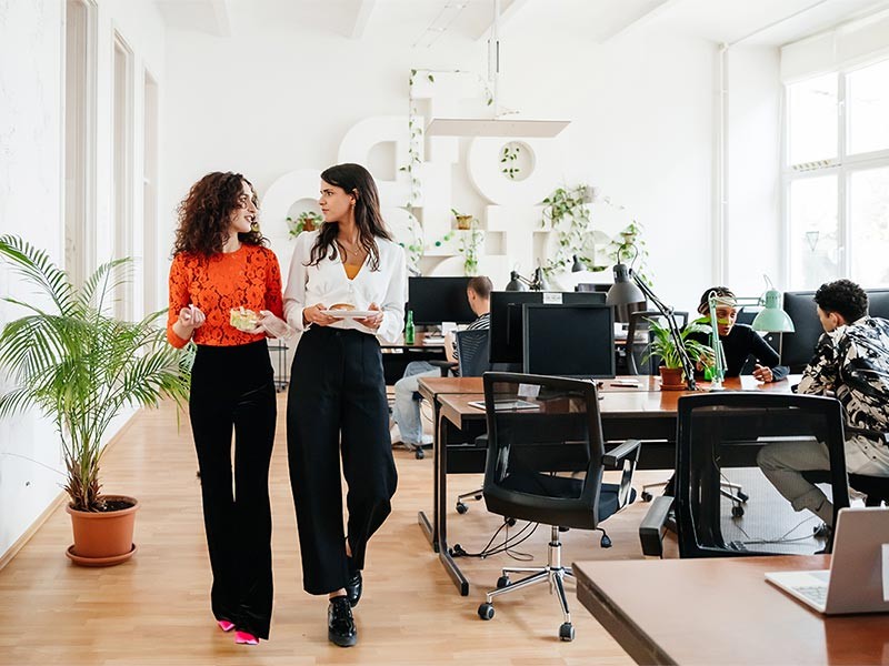 Colleagues walk through a modern office set up