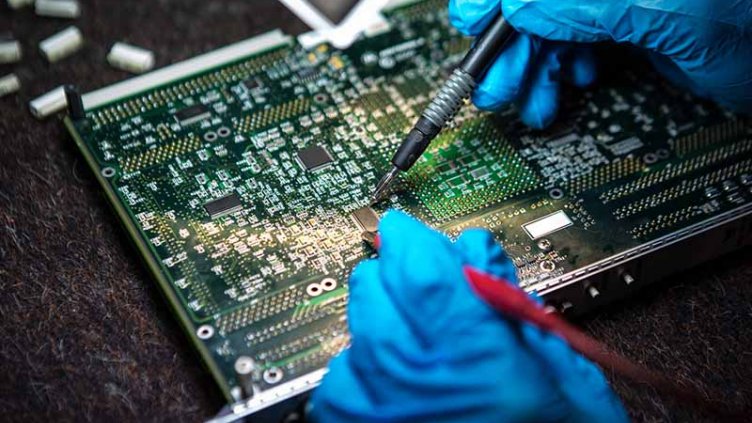 Men working on circuit board
