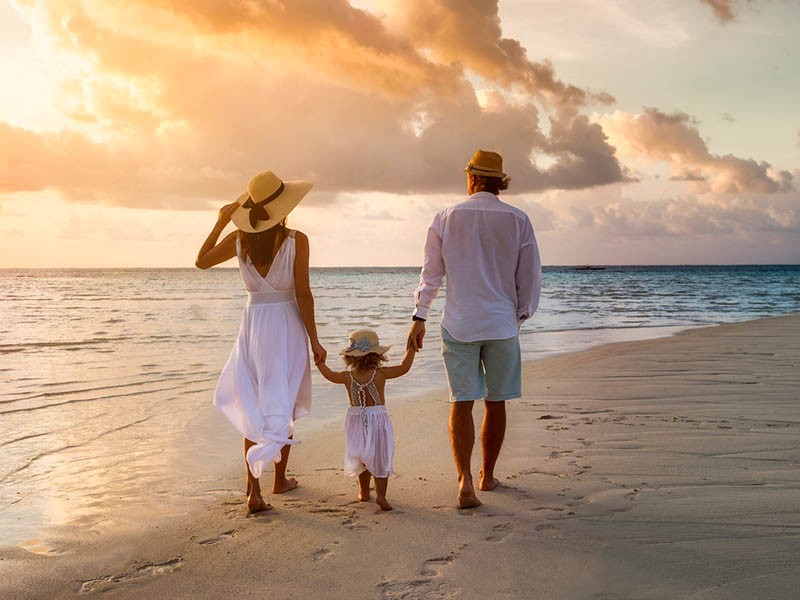 Family enjoying the sunset on beach side