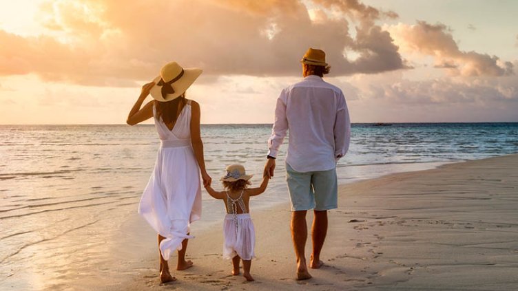 Family enjoying the sunset on beach side