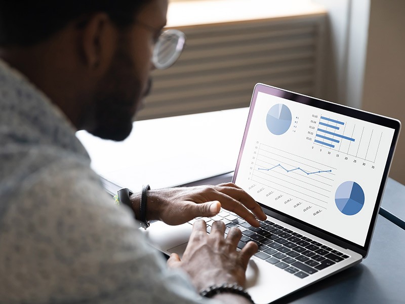 Young professional checking real estate data on his laptop