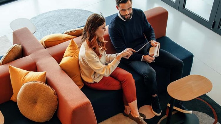 Professional man and a woman discussing data