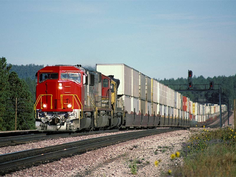 Train running on railway trackers with logistics containers