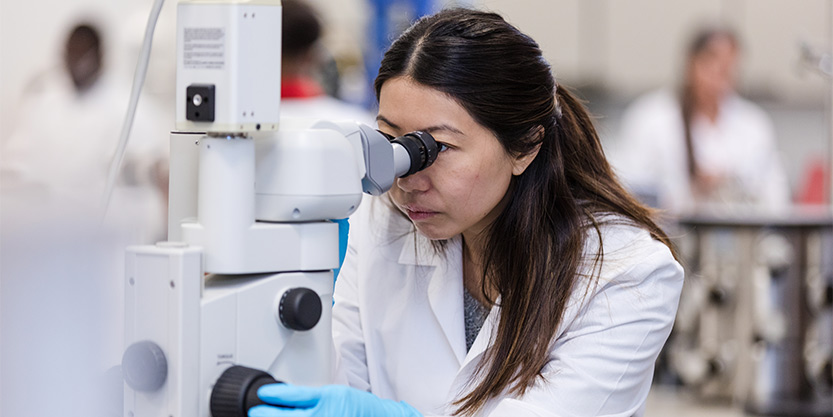 Doctor Looking Into Microscope