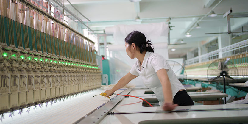 A woman is working in manufacturing plant