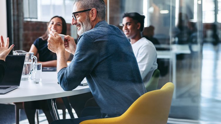 Small team meeting at table in office