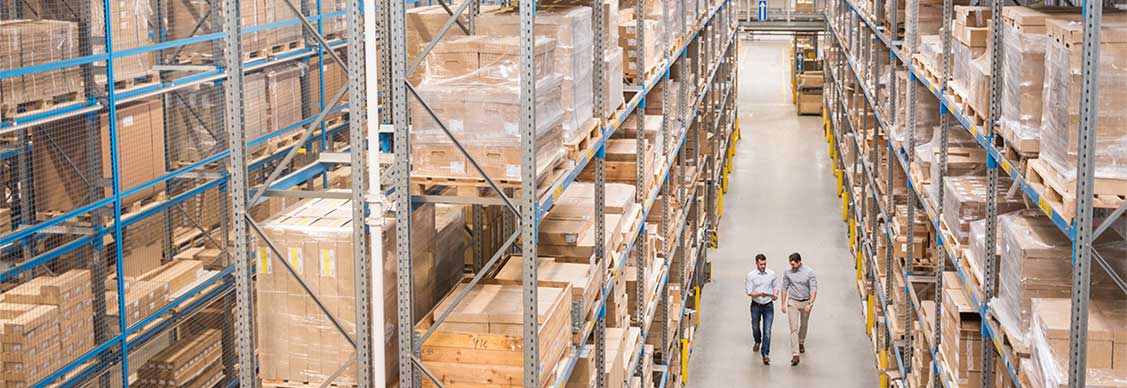 Two men walking in the warehouse