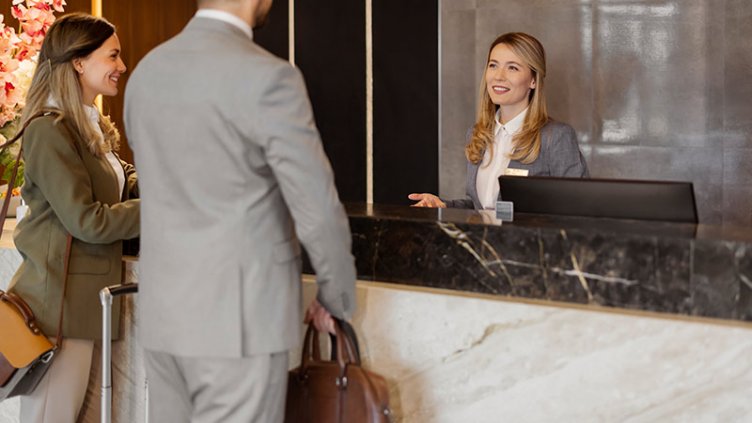 Couples talking with receptionist 