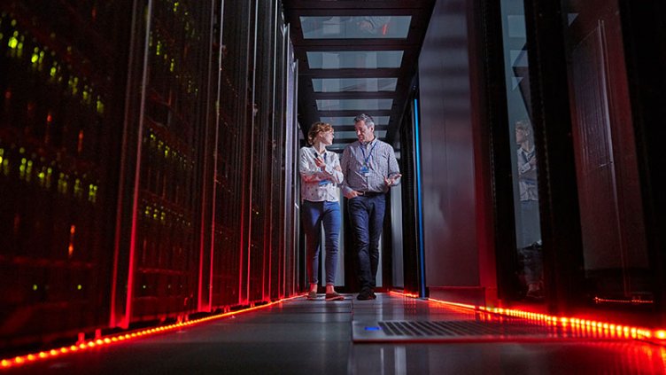 IT technicians walking in dark server room