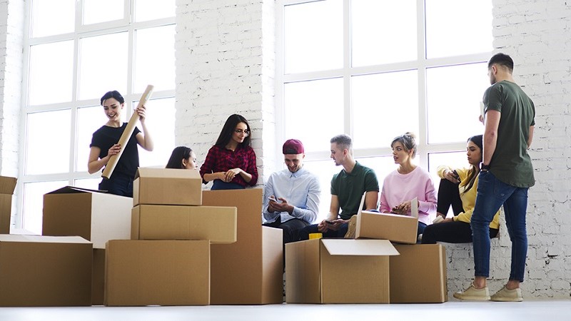 Colleagues unpacking the boxes at he new office space