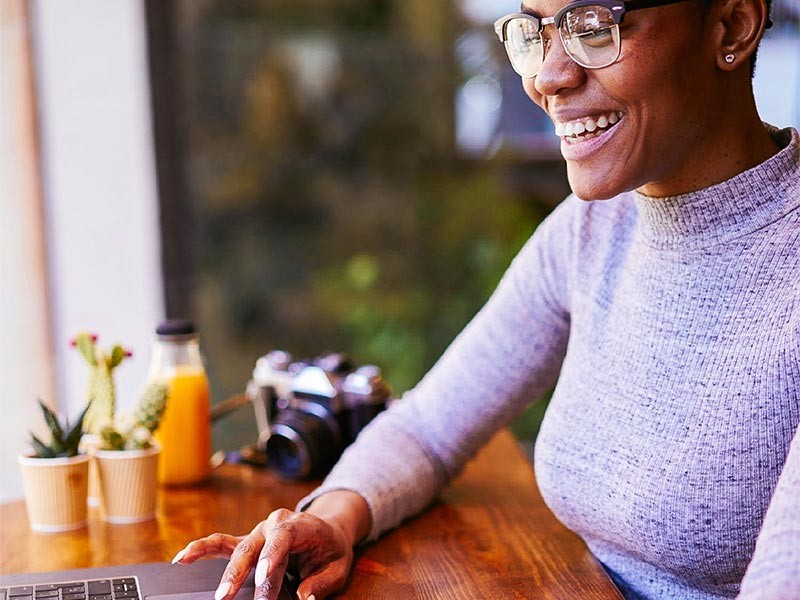 Smiling woman working on laptop